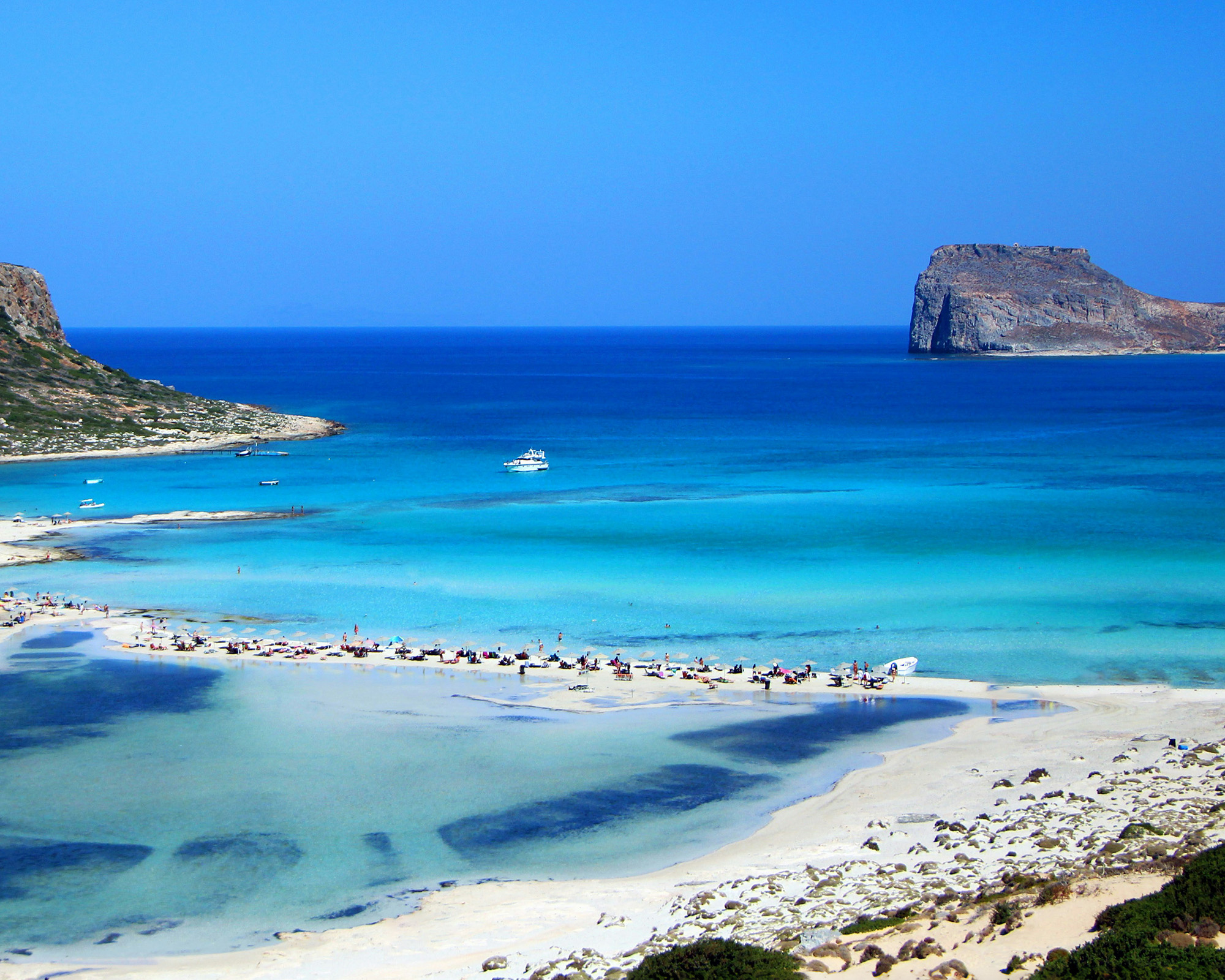 Situated on the northwest coast of Crete, Balos Lagoon is a breathtaking natural wonder with shallow turquoise waters, white sandbars, and pink-hued sand.