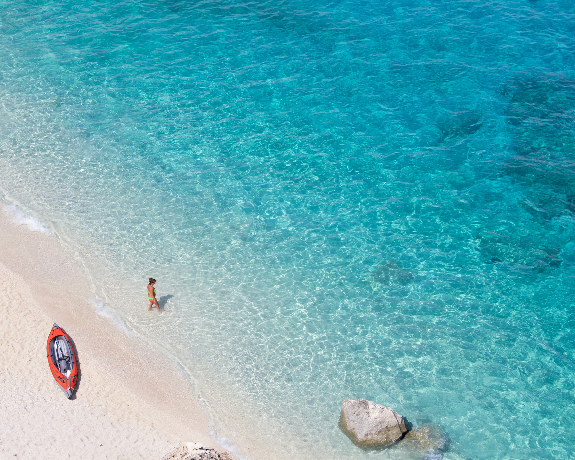 Cala Macarelleta is a small, secluded beach with powdery white sand and clear turquoise waters